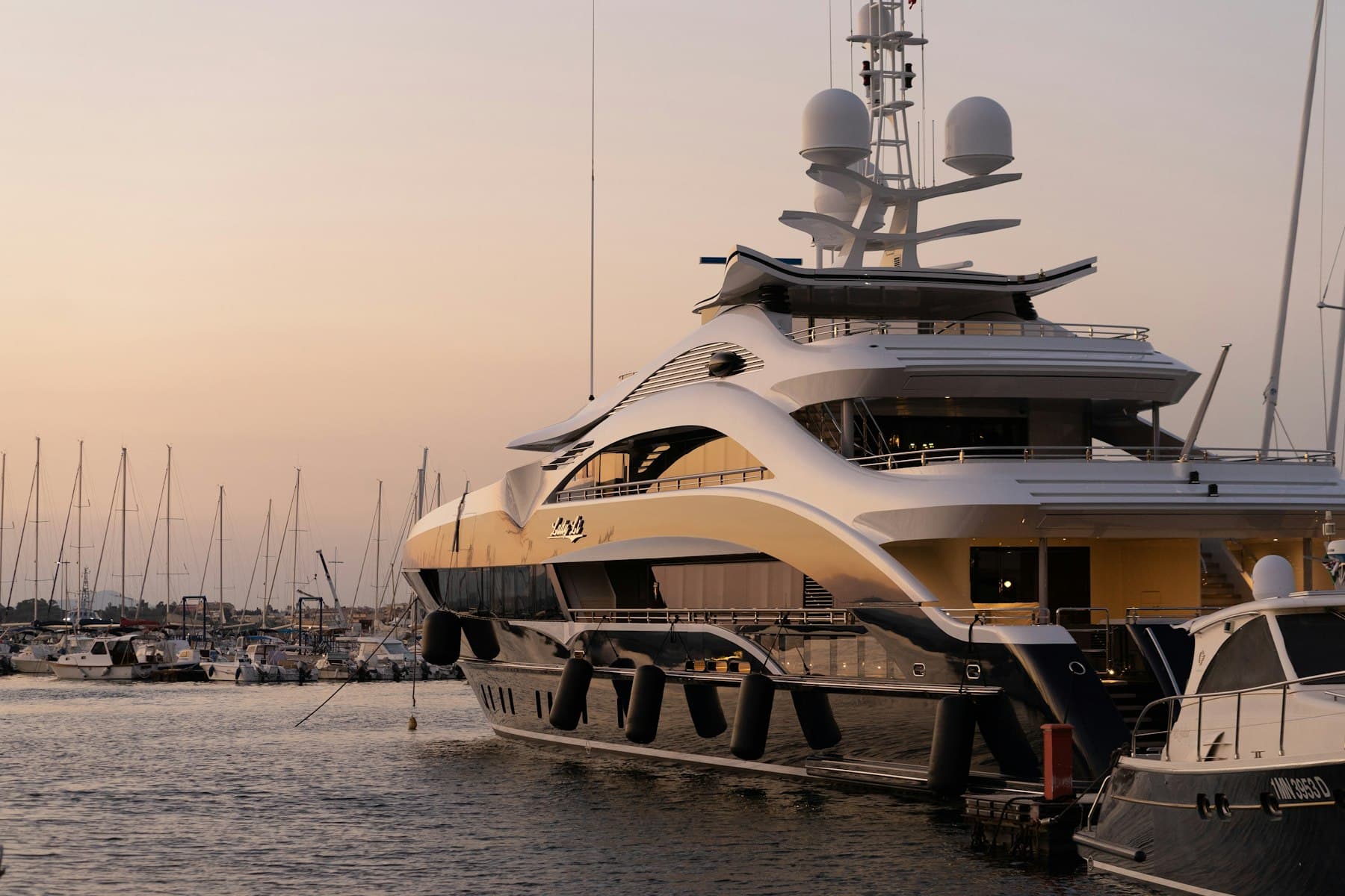 Superyachts berthed at dusk in a Mediterranean marina