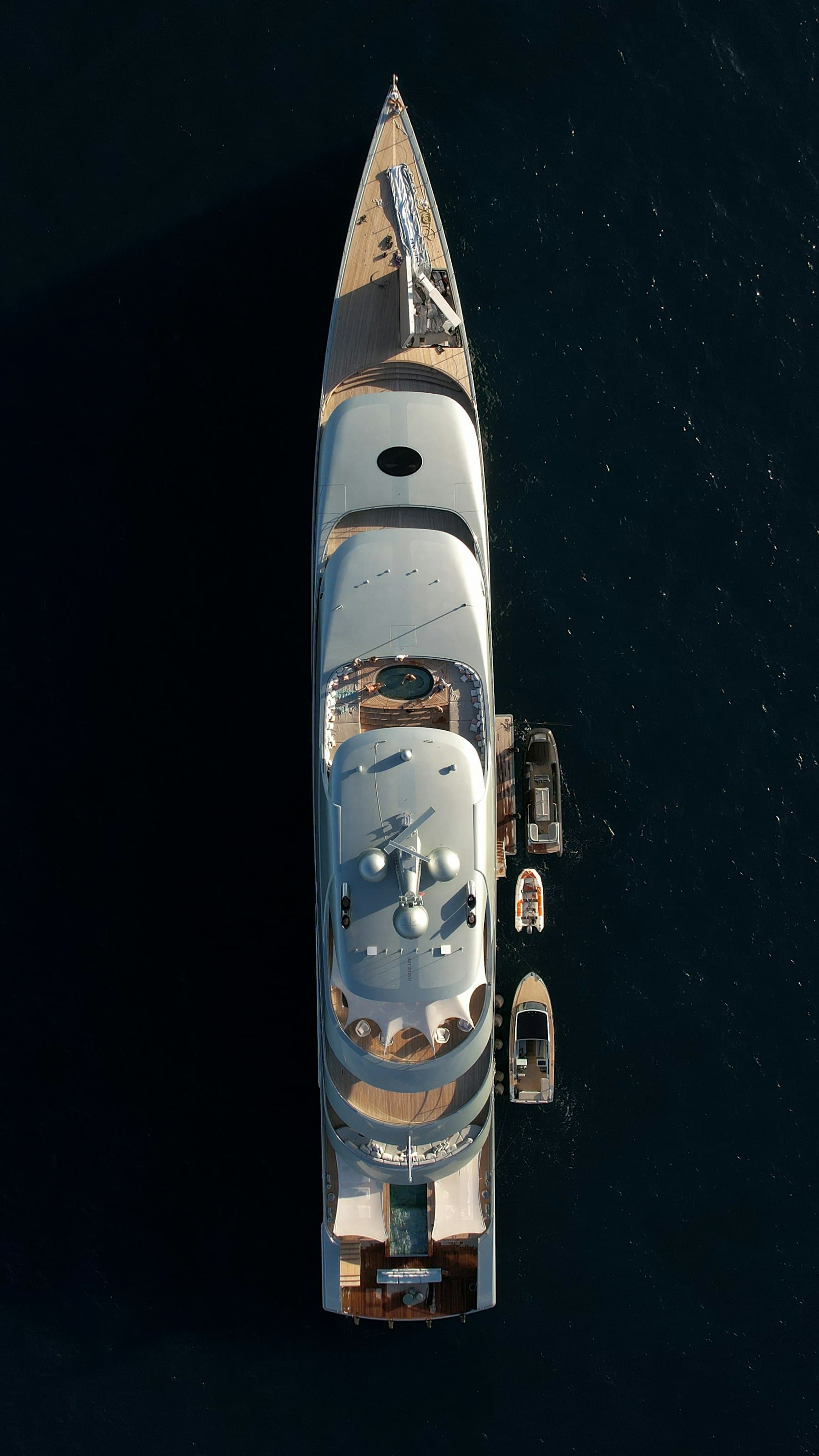 Aerial view of a superyacht on dark water